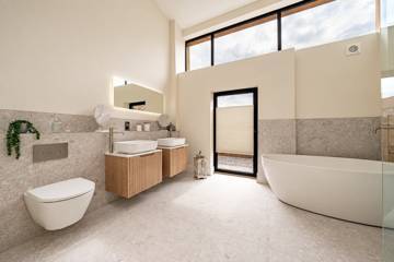 Bathroom with freestanding bath and twin basins