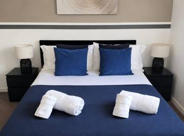 Bedroom with navy throw