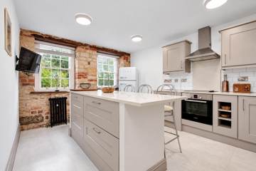Kitchen with island and exposed stone