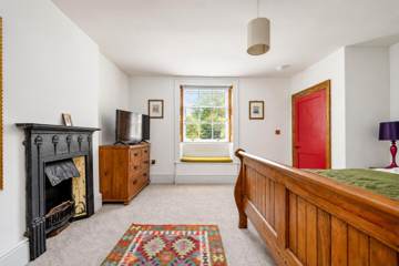 Bedroom with cast-iron fireplace